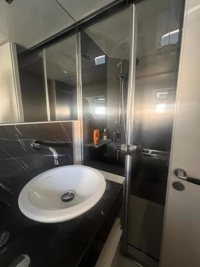  Yacht Photos Pics Luxurious bathroom on 2015 Arcadia Yachts A 85, featuring modern sink and glass shower.
