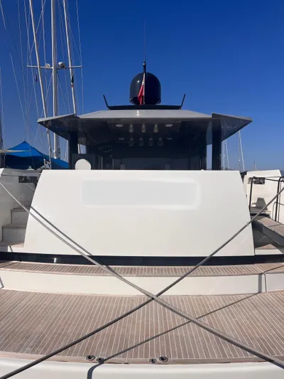  Yacht Photos Pics 2015 Arcadia Yachts A 85, sleek design, docked under clear blue sky.