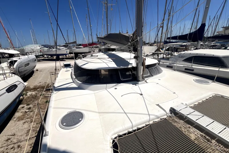  Yacht Photos Pics 2002 Fountaine Pajot LAVEZZI 40 catamaran docked among other boats under clear blue sky.