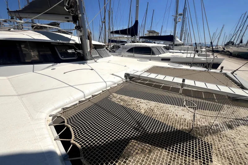  Yacht Photos Pics Fountaine Pajot LAVEZZI 40 catamaran, 2002 model, docked in a marina under clear skies.