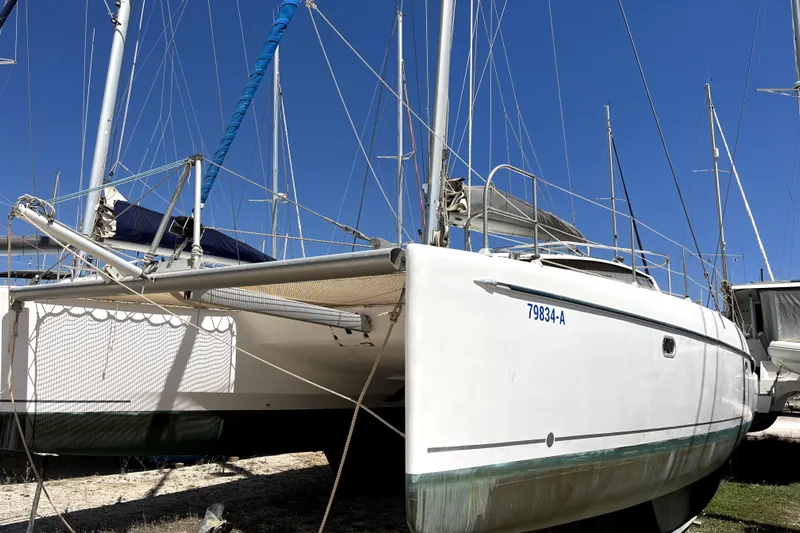  Yacht Photos Pics 2002 Fountaine Pajot LAVEZZI 40 catamaran on land, blue sky background.