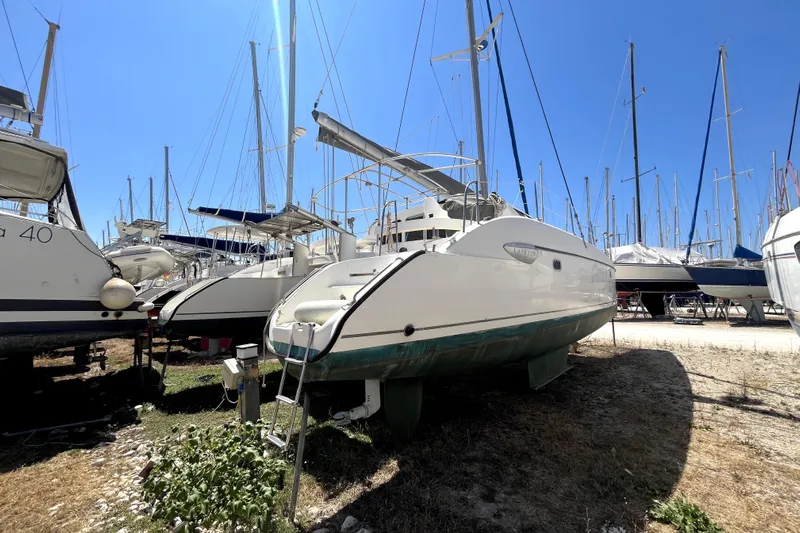  Yacht Photos Pics 2002 Fountaine Pajot LAVEZZI 40 catamaran on dry dock, surrounded by other boats.