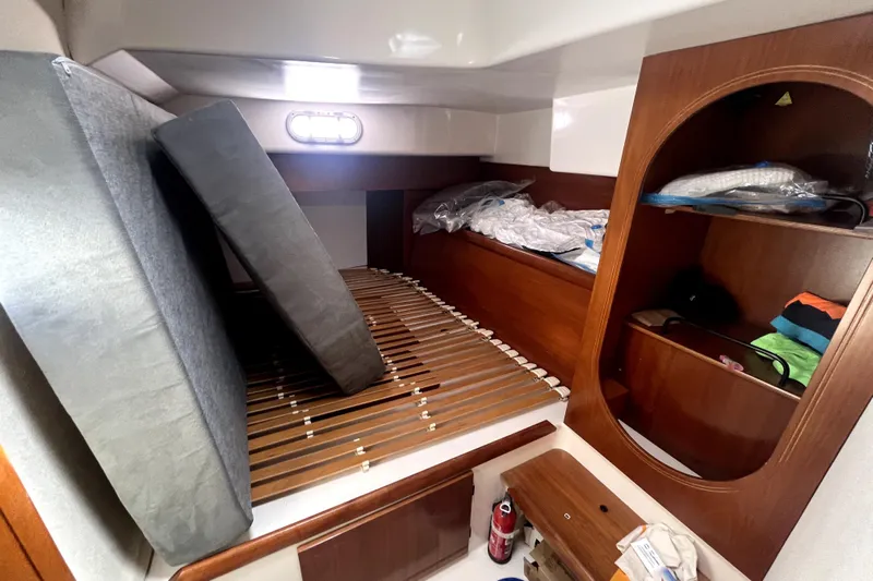  Yacht Photos Pics Interior cabin of 2002 Fountaine Pajot LAVEZZI 40 with wooden shelves and mattress.