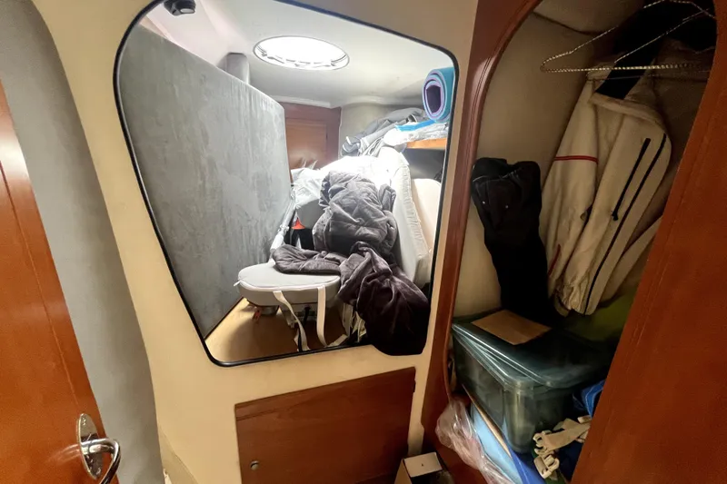  Yacht Photos Pics Interior of 2002 Fountaine Pajot LAVEZZI 40, showing cluttered cabin with storage and clothing.