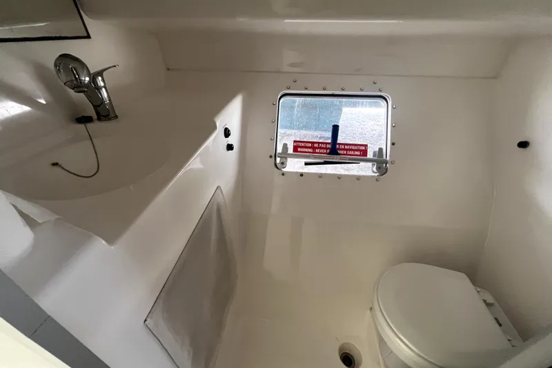  Yacht Photos Pics Bathroom interior of 2002 Fountaine Pajot LAVEZZI 40 catamaran, featuring sink and toilet.