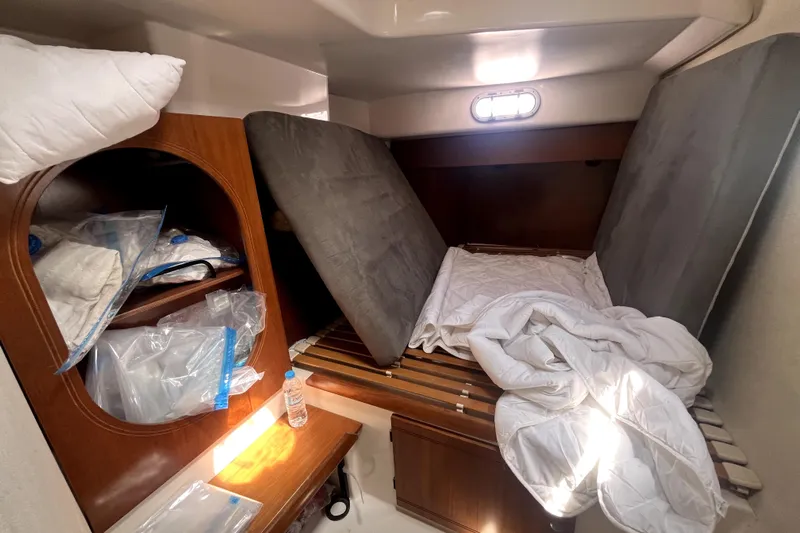  Yacht Photos Pics Cozy cabin interior of 2002 Fountaine Pajot LAVEZZI 40 catamaran with bedding and storage.