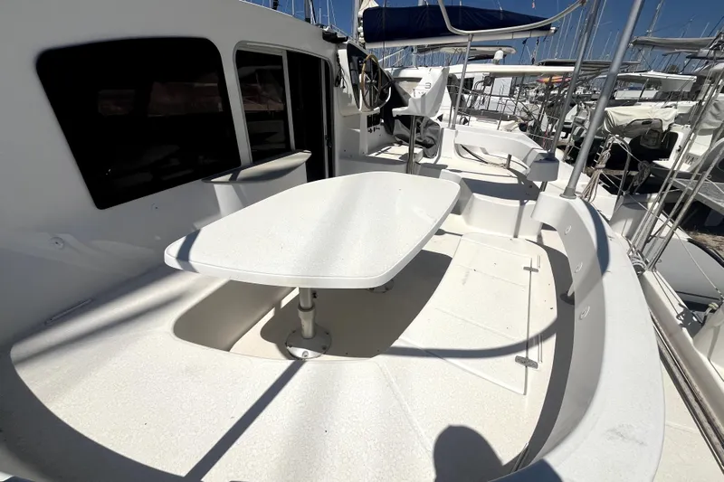 Yacht Photos Pics 2002 Fountaine Pajot LAVEZZI 40 catamaran deck with seating and table, docked in marina.