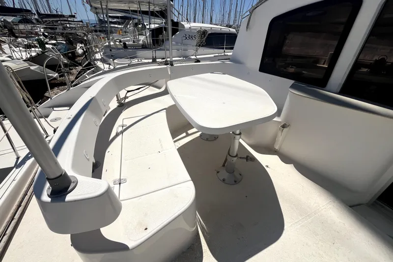  Yacht Photos Pics Spacious deck seating area on 2002 Fountaine Pajot LAVEZZI 40 catamaran, docked in marina.