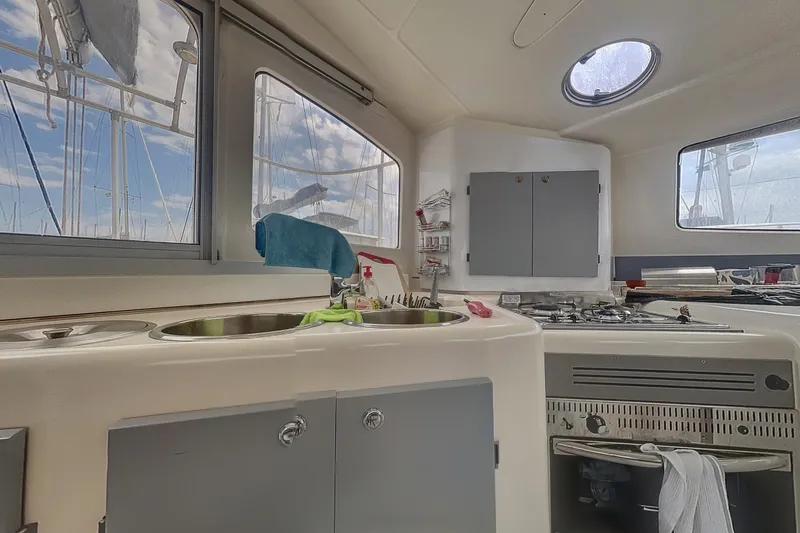  Yacht Photos Pics Interior view of 2002 Fountaine Pajot LAVEZZI 40 catamaran kitchen with sink and stove.