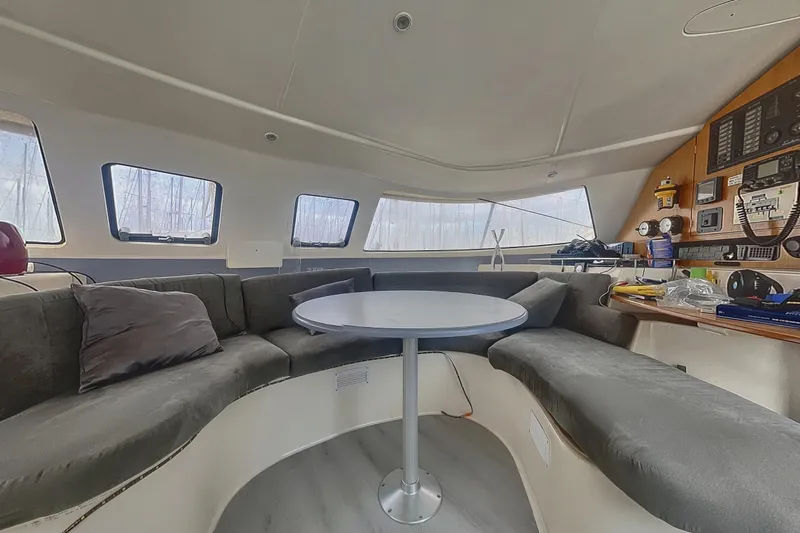  Yacht Photos Pics Interior of 2002 Fountaine Pajot LAVEZZI 40 catamaran with cozy seating and navigation equipment.