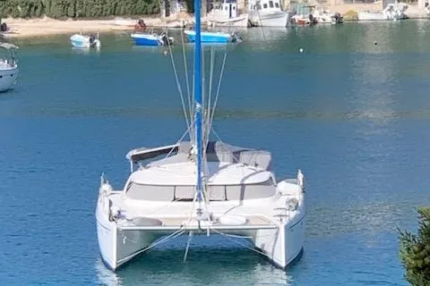  Yacht Photos Pics 2002 Fountaine Pajot LAVEZZI 40 catamaran docked in a serene harbor.