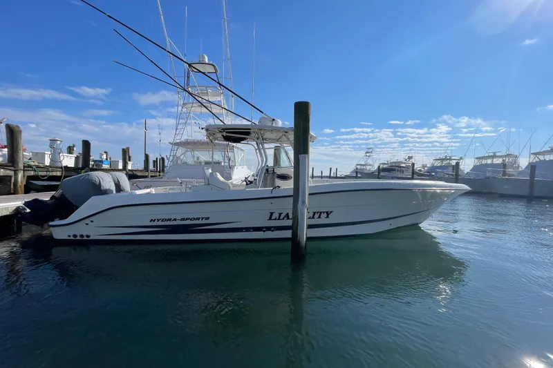  Yacht Photos Pics 2003 Hydra-Sports Vector 3300 CC boat docked in a marina under a clear blue sky.