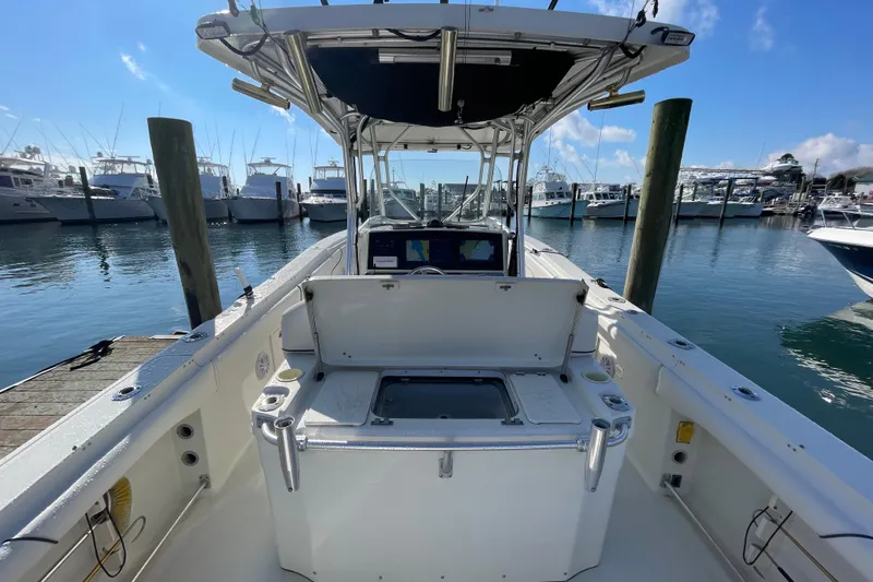 Yacht Photos Pics 2003 Hydra-Sports Vector 3300 CC boat docked at marina, clear sky, calm water.