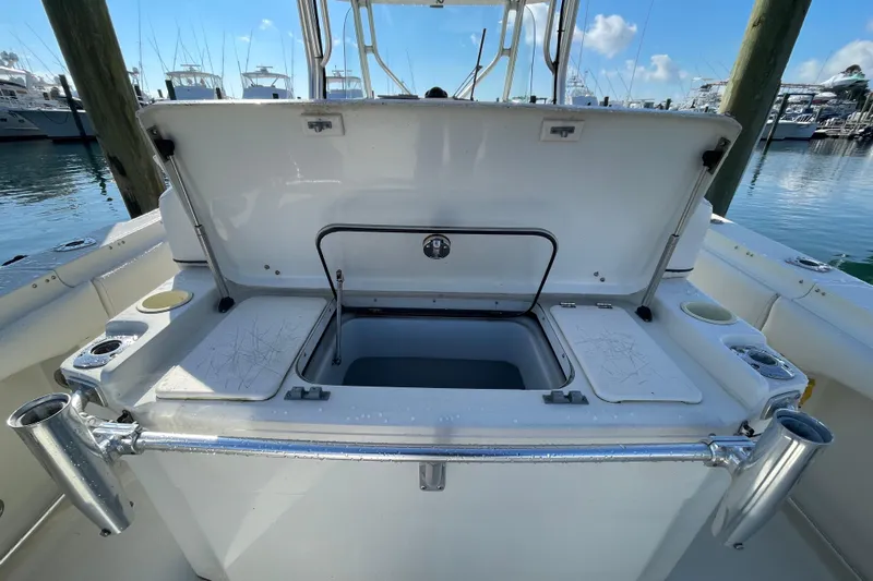  Yacht Photos Pics 2003 Hydra-Sports Vector 3300 CC boat with open storage compartment at marina.