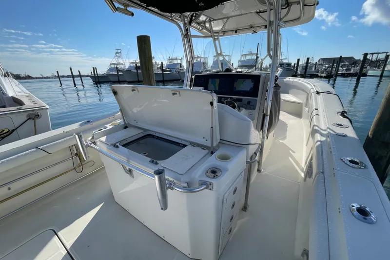  Yacht Photos Pics 2003 Hydra-Sports Vector 3300 CC boat interior at marina, featuring helm and storage.