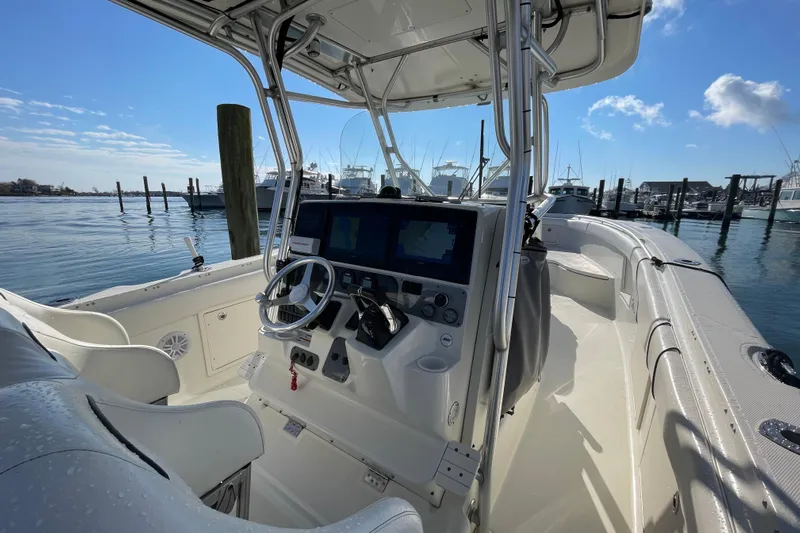  Yacht Photos Pics 2003 Hydra-Sports Vector 3300 CC boat interior with steering wheel and navigation screens.