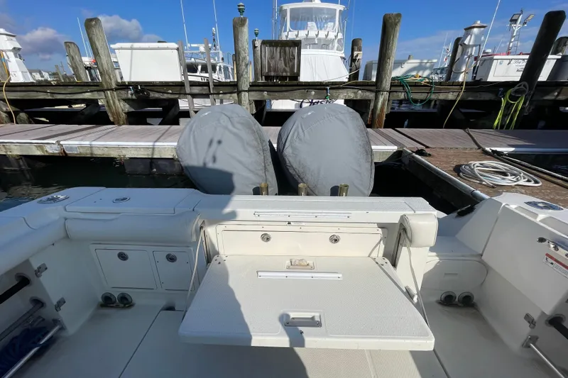  Yacht Photos Pics 2003 Hydra-Sports Vector 3300 CC at dock, featuring covered engines and spacious deck.