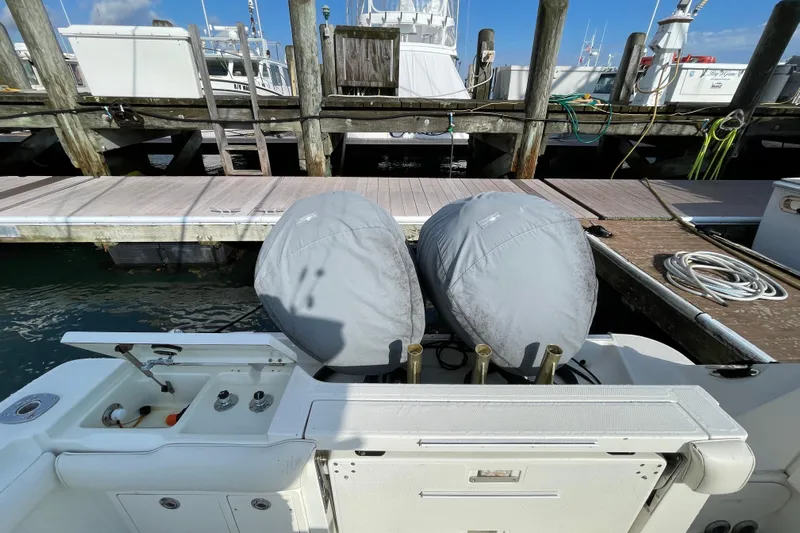  Yacht Photos Pics 2003 Hydra-Sports Vector 3300 CC at dock with covered engines and fishing equipment.