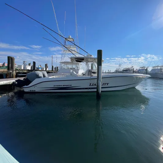  Yacht Photos Pics 2003 Hydra-Sports Vector 3300 CC boat docked in a marina under a clear blue sky.