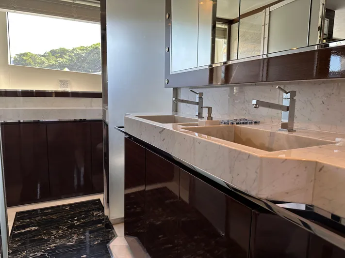 Bbella Yacht Photos Pics Luxurious bathroom in 2014 Cheoy Lee Alpha 87 Express Sportbridge yacht with dual sinks and elegant finishes.