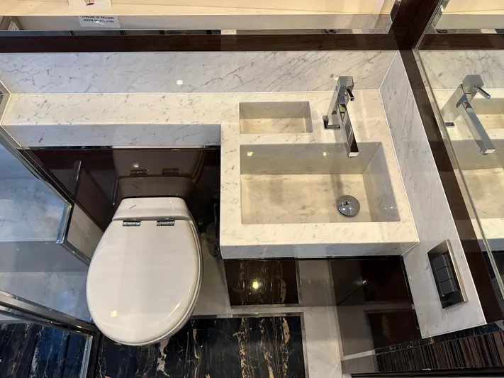 Bbella Yacht Photos Pics Luxurious bathroom in 2014 Cheoy Lee Alpha 87 Express Sportbridge yacht, featuring marble sink and modern fixtures.