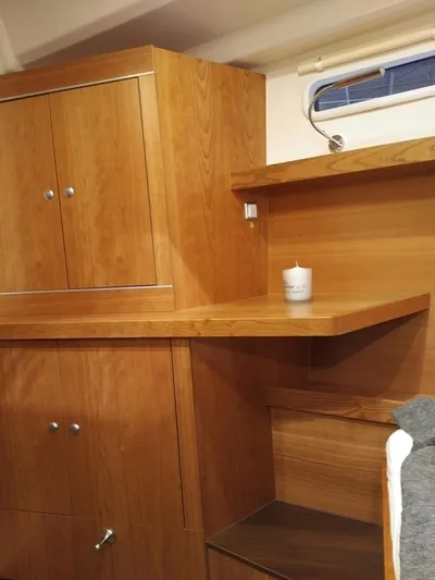  Yacht Photos Pics Interior of 2017 Hanse HANSE 415 yacht with wooden cabinetry and small window.