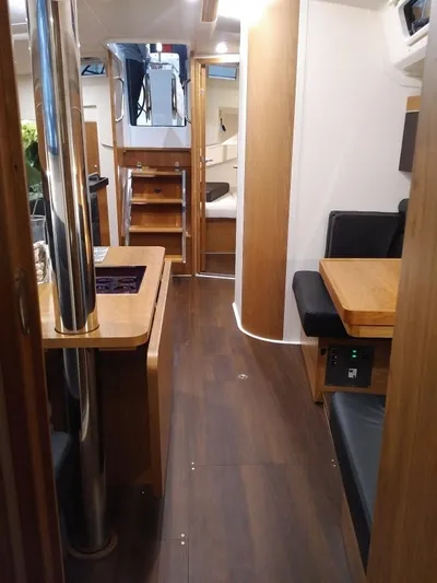  Yacht Photos Pics Interior of 2017 Hanse HANSE 415 yacht with modern wood finish and seating area.