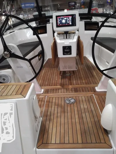  Yacht Photos Pics 2017 Hanse HANSE 415 yacht cockpit with dual steering wheels and wooden flooring.