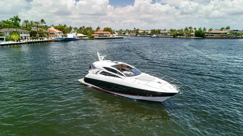 Arbitrage Yacht Photos Pics 2017 Sunseeker Predator 57 yacht cruising on a scenic waterway.