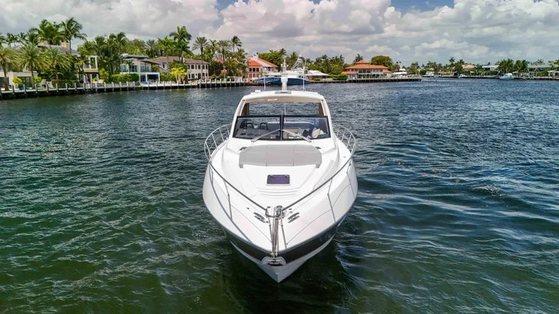 Arbitrage Yacht Photos Pics 2017 Sunseeker Predator 57 yacht on a scenic waterfront with palm trees.