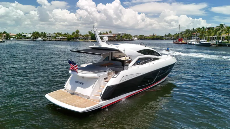Arbitrage Yacht Photos Pics 2017 Sunseeker Predator 57 yacht cruising on a sunny day, featuring sleek design and luxury amenities.