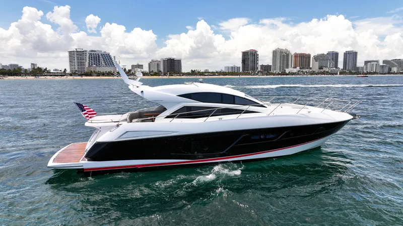 Arbitrage Yacht Photos Pics 2017 Sunseeker Predator 57 yacht cruising near city skyline on a sunny day.