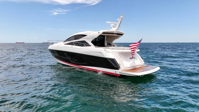 Arbitrage Yacht Photos Pics 2017 Sunseeker Predator 57 yacht cruising on open sea with American flag.