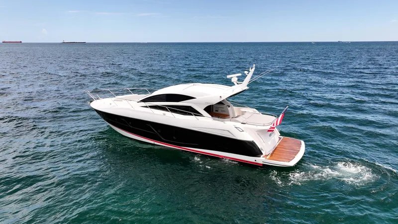 Arbitrage Yacht Photos Pics 2017 Sunseeker Predator 57 yacht cruising on open sea, showcasing sleek design and luxury.