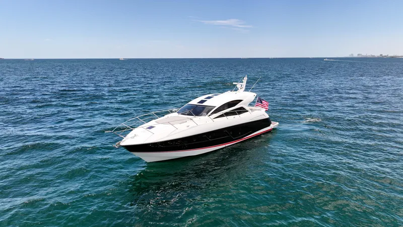 Arbitrage Yacht Photos Pics 2017 Sunseeker Predator 57 yacht cruising on open sea under clear blue sky.