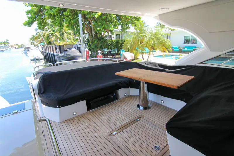 Arbitrage Yacht Photos Pics Luxurious Sunseeker Predator 57 yacht deck with seating and table, 2017 model.