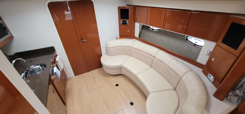  Yacht Photos Pics Interior of a 2012 Formula 37 Performance Cruiser with leather sofa and wooden cabinetry.
