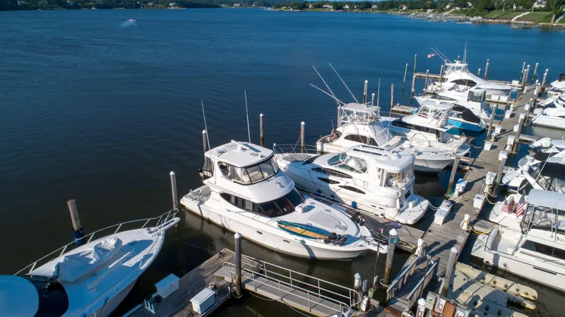  Yacht Photos Pics 2006 Silverton 50 Convertible yacht docked at marina, surrounded by other boats.