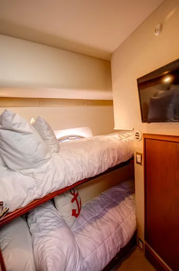  Yacht Photos Pics Bunk beds in 2006 Silverton 50 Convertible yacht cabin with TV and anchor-themed decor.