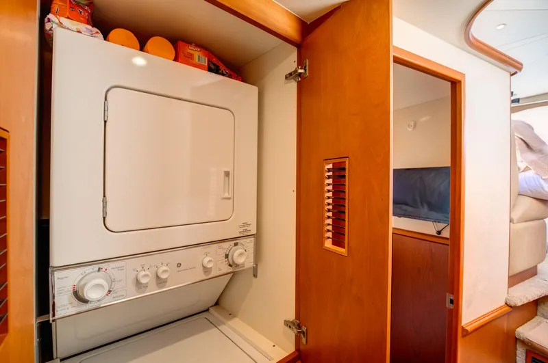  Yacht Photos Pics Laundry area inside 2006 Silverton 50 Convertible yacht with stacked washer and dryer.