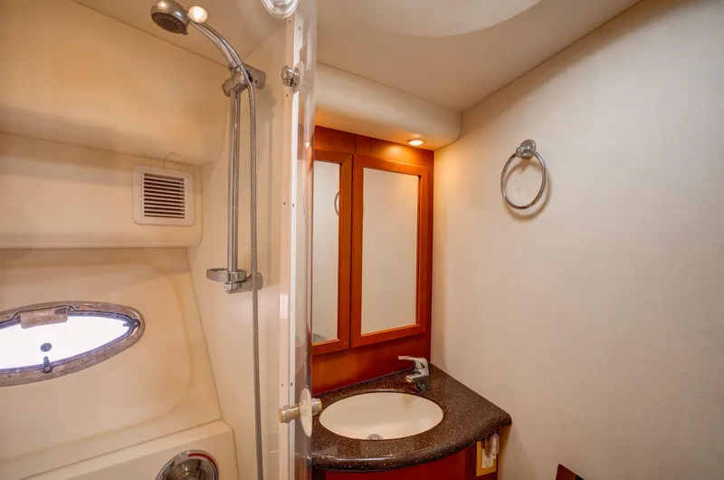  Yacht Photos Pics 2006 Silverton 50 Convertible yacht bathroom with shower, sink, and mirror.