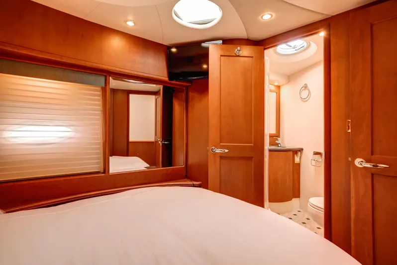  Yacht Photos Pics Luxurious interior of 2006 Silverton 50 Convertible yacht with wood finishes and ensuite bathroom.