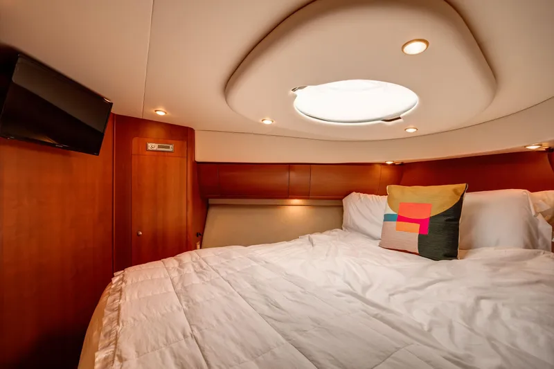  Yacht Photos Pics Luxurious bedroom interior of 2006 Silverton 50 Convertible yacht with modern decor.