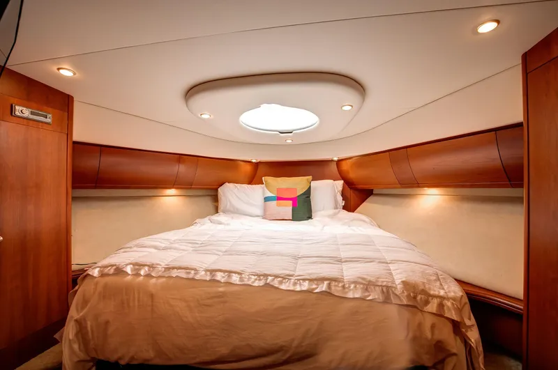  Yacht Photos Pics Luxurious bedroom interior of 2006 Silverton 50 Convertible yacht with cozy bedding.