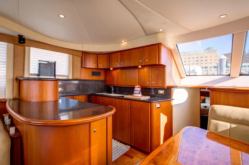  Yacht Photos Pics Luxurious interior of a 2006 Silverton 50 Convertible yacht with elegant wood cabinetry.