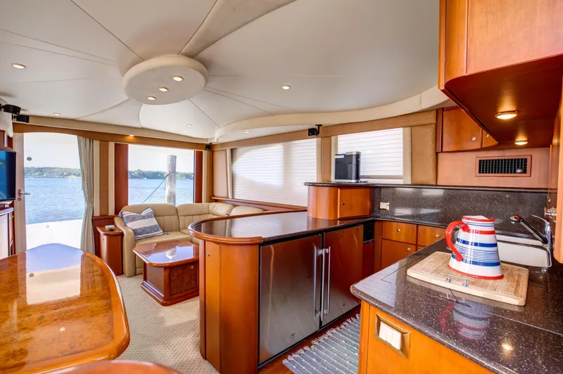  Yacht Photos Pics Luxurious interior of 2006 Silverton 50 Convertible yacht with modern kitchen and seating area.