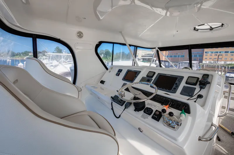  Yacht Photos Pics 2006 Silverton 50 Convertible yacht cockpit with modern navigation equipment and plush seating.
