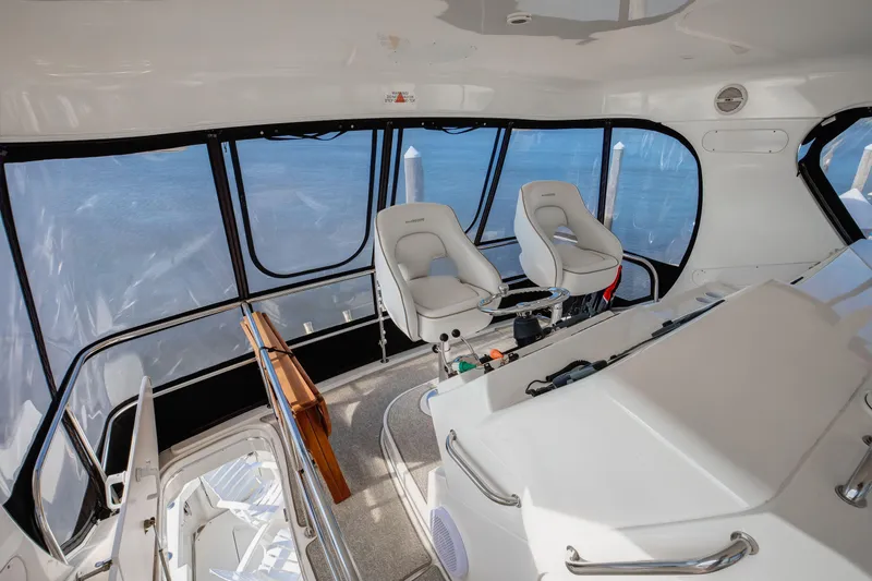  Yacht Photos Pics Interior view of 2006 Silverton 50 Convertible yacht cockpit with two captain chairs.