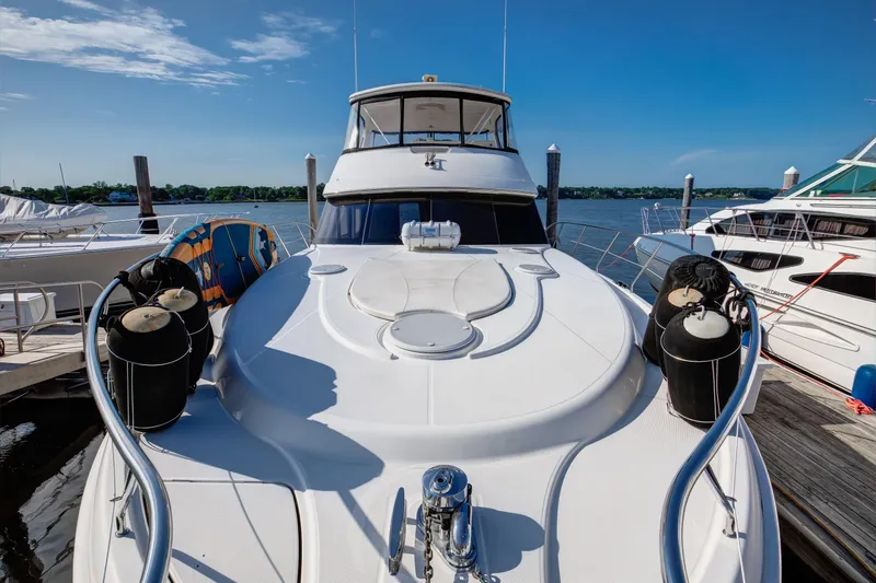  Yacht Photos Pics 2006 Silverton 50 Convertible yacht docked at marina under clear blue sky.