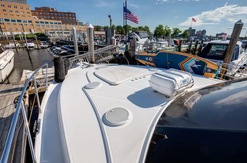 Yacht Photos Pics 2006 Silverton 50 Convertible yacht docked at marina with American flags.